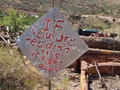 Bullet holes in sign